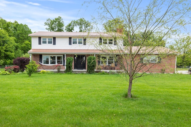 4736 Roberts Rd, Caledonia, OH 43314 - view of front facade with a front yard, metal roof, a chimney, and brick siding