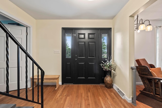 4736 Roberts Rd, Caledonia, OH 43314 - foyer entrance with stairs, light wood finished floors, baseboards, and a chandelier