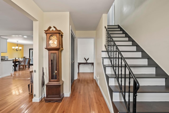 4736 Roberts Rd, Caledonia, OH 43314 - stairway with hardwood / wood-style floors, a chandelier, and baseboards