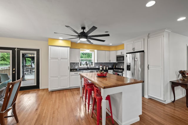 4736 Roberts Rd, Caledonia, OH 43314 - kitchen with stainless steel appliances, wood counters, white cabinetry, light wood-style floors, and ceiling fan