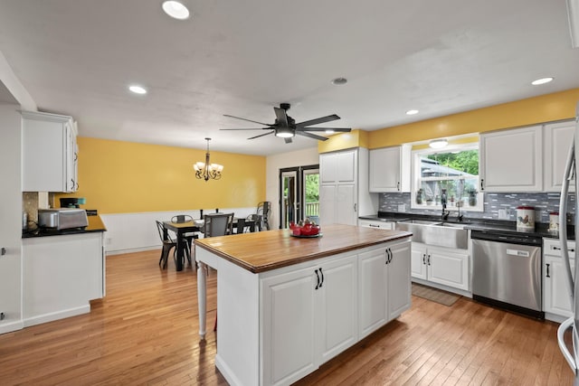 4736 Roberts Rd, Caledonia, OH 43314 - kitchen with dishwasher, a sink, white cabinets, light wood-style floors, and decorative backsplash