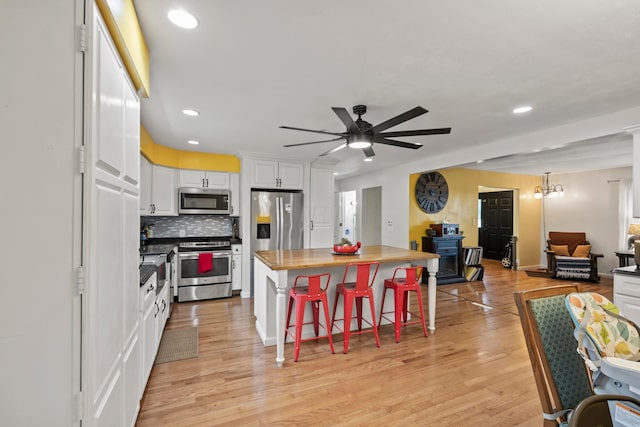 4736 Roberts Rd, Caledonia, OH 43314 - kitchen with appliances with stainless steel finishes, open floor plan, white cabinetry, recessed lighting, and a ceiling fan