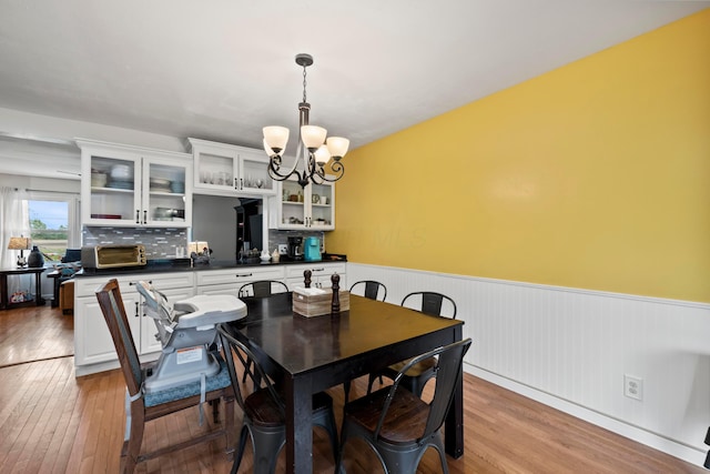 4736 Roberts Rd, Caledonia, OH 43314 - dining room featuring a chandelier, a wainscoted wall, and hardwood / wood-style floors