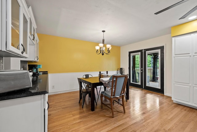 4736 Roberts Rd, Caledonia, OH 43314 - dining room featuring light wood-type flooring, a wainscoted wall, and a chandelier