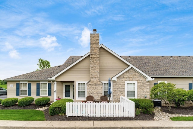 6621 Eagle Ridge Ln Unit 9C, Canal Winchester, OH 43110 - view of front of property featuring a shingled roof, a chimney, and stone siding