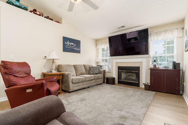 6621 Eagle Ridge Ln Unit 9C, Canal Winchester, OH 43110 - living room featuring wood finished floors, ceiling fan, a tile fireplace, vaulted ceiling, and baseboards