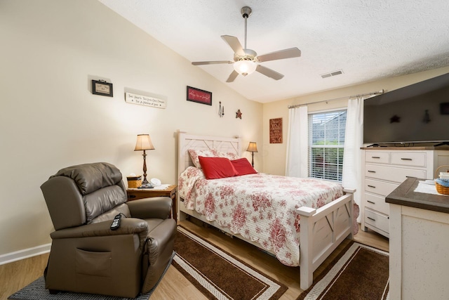 6621 Eagle Ridge Ln Unit 9C, Canal Winchester, OH 43110 - bedroom with wood finished floors, lofted ceiling, a ceiling fan, a textured ceiling, and baseboards