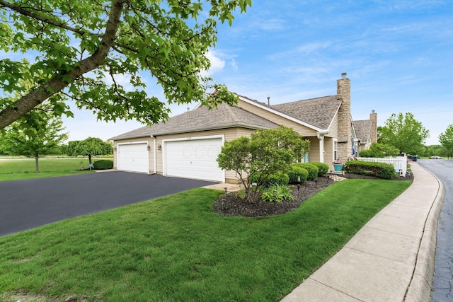 6621 Eagle Ridge Ln Unit 9C, Canal Winchester, OH 43110 - view of property exterior with a lawn, a chimney, asphalt driveway, and a shingled roof