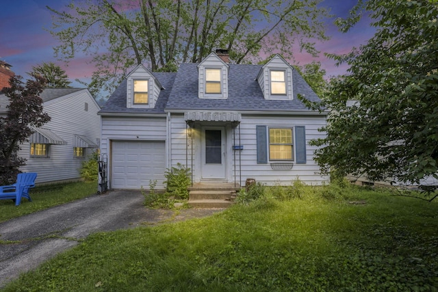 104 W Rathbone Ave, Columbus, OH 43214 - cape cod house with a chimney, a garage, a shingled roof, and driveway