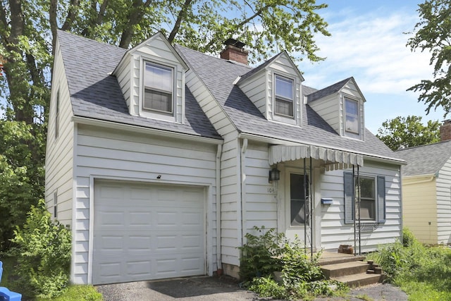 104 W Rathbone Ave, Columbus, OH 43214 - new england style home with an attached garage, a chimney, roof with shingles, and driveway