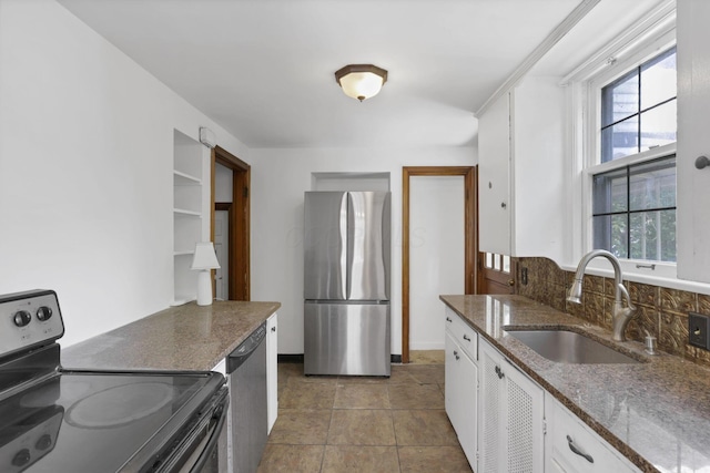 104 W Rathbone Ave, Columbus, OH 43214 - kitchen featuring stainless steel appliances, a sink, white cabinets, and dark stone countertops