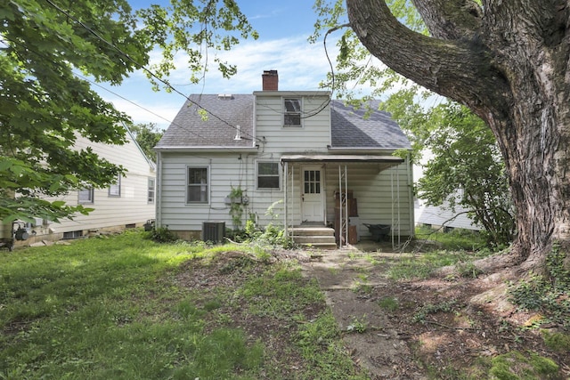 104 W Rathbone Ave, Columbus, OH 43214 - rear view of property featuring a chimney, a shingled roof, and central AC