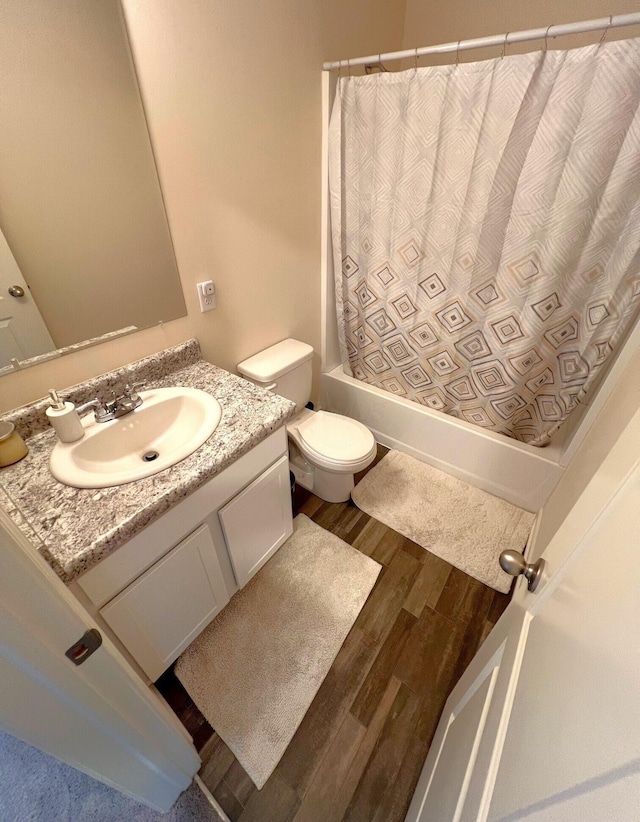 324 Genoa Rd, Commercial Point, OH 43116 - full bath with vanity, shower / bathtub combination with curtain, wood finished floors, and toilet