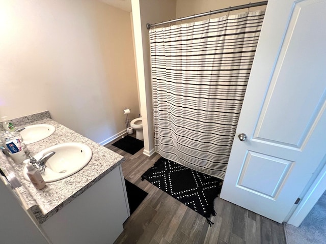 324 Genoa Rd, Commercial Point, OH 43116 - full bath with wood finished floors, double vanity, toilet, and curtained shower