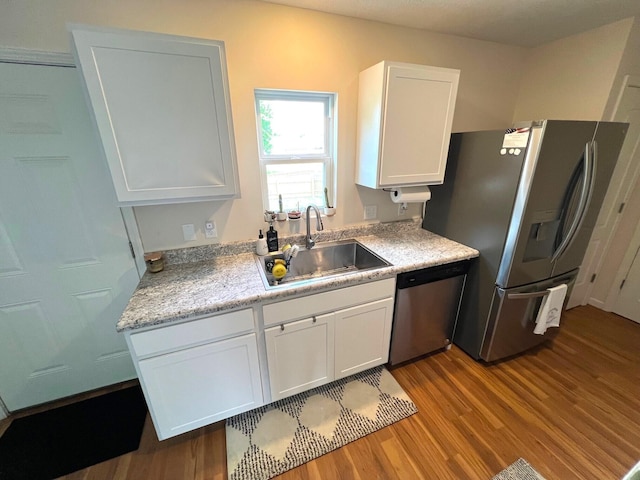 324 Genoa Rd, Commercial Point, OH 43116 - kitchen featuring appliances with stainless steel finishes, a sink, wood finished floors, and white cabinets