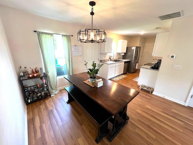 324 Genoa Rd, Commercial Point, OH 43116 - dining room featuring a chandelier, light wood-style floors, and baseboards