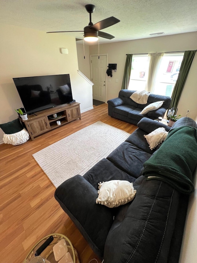 324 Genoa Rd, Commercial Point, OH 43116 - living area featuring wood finished floors, a ceiling fan, a textured ceiling, and baseboards