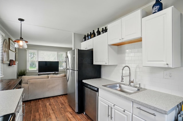 4367 San Jose Ln, Columbus, OH 43213 - kitchen featuring appliances with stainless steel finishes, a sink, open floor plan, tasteful backsplash, and dark wood-style floors