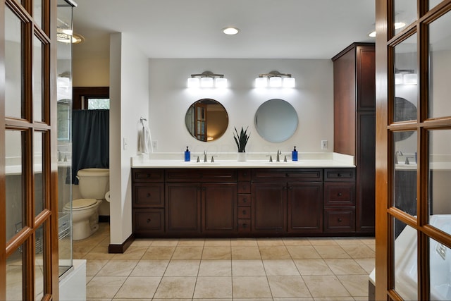 72 Glenmont Ave, Columbus, OH 43214 - full bathroom featuring toilet, double vanity, tile patterned floors, and recessed lighting