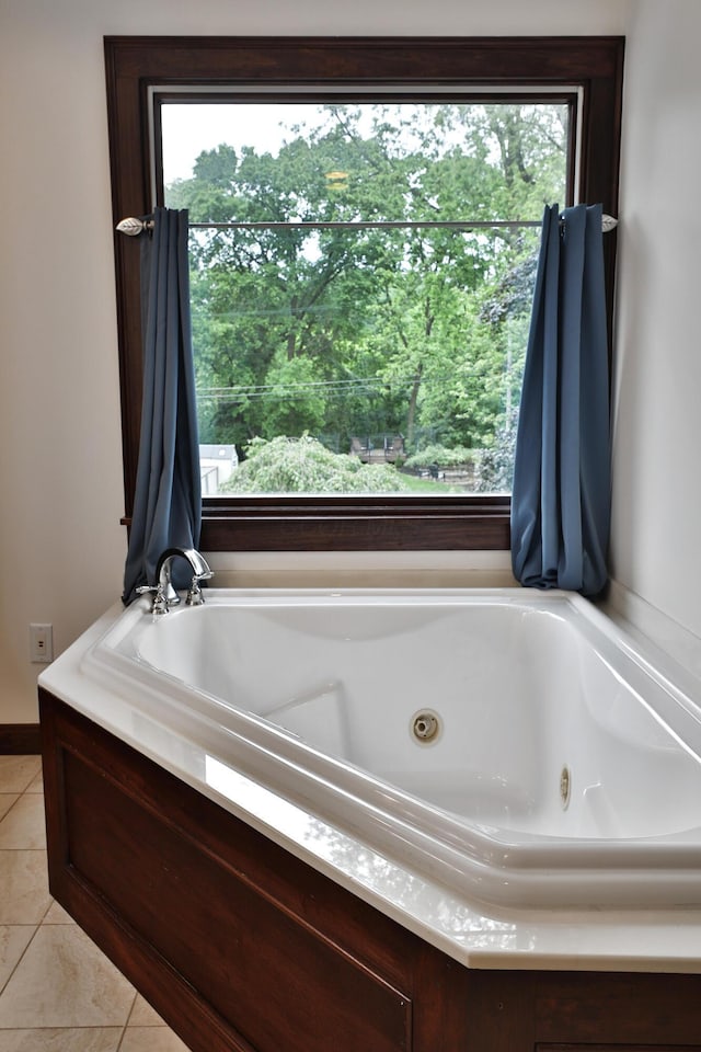 72 Glenmont Ave, Columbus, OH 43214 - bathroom with healthy amount of natural light, a jetted tub, and tile patterned floors