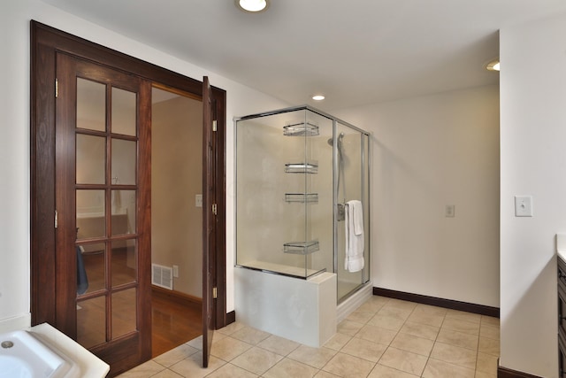 72 Glenmont Ave, Columbus, OH 43214 - bathroom featuring a stall shower, baseboards, recessed lighting, and tile patterned flooring
