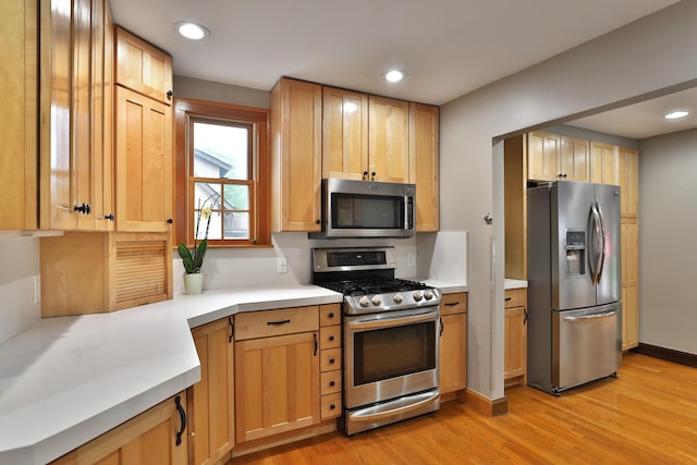 72 Glenmont Ave, Columbus, OH 43214 - kitchen featuring appliances with stainless steel finishes, light wood finished floors, light countertops, recessed lighting, and baseboards