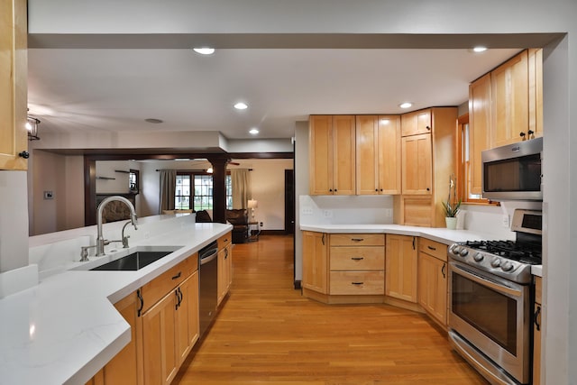 72 Glenmont Ave, Columbus, OH 43214 - kitchen featuring appliances with stainless steel finishes, a sink, light wood-style floors, light brown cabinetry, and recessed lighting