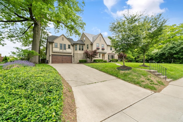 2656 Fair Ave, Columbus, OH 43209 - french provincial home featuring an attached garage, stone siding, stucco siding, driveway, and a front lawn