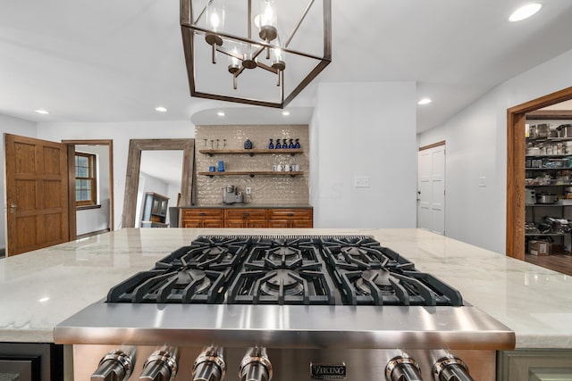 2656 Fair Ave, Columbus, OH 43209 - kitchen with recessed lighting, light stone counters, a chandelier, open shelves, and stainless steel gas range oven