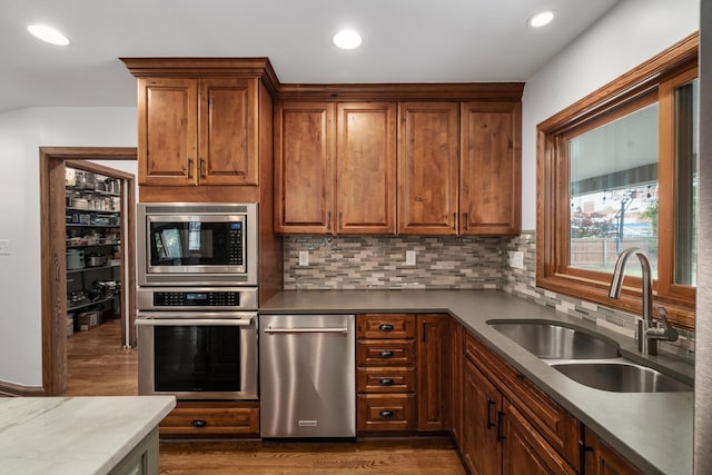 2656 Fair Ave, Columbus, OH 43209 - kitchen with appliances with stainless steel finishes, a sink, dark wood-type flooring, tasteful backsplash, and recessed lighting