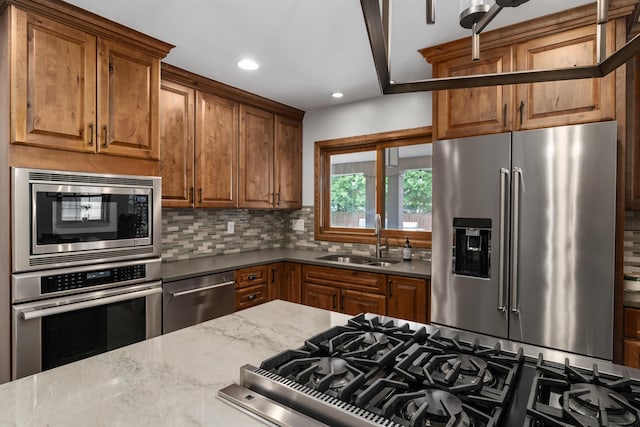 2656 Fair Ave, Columbus, OH 43209 - kitchen featuring stainless steel appliances, a sink, decorative backsplash, recessed lighting, and brown cabinetry