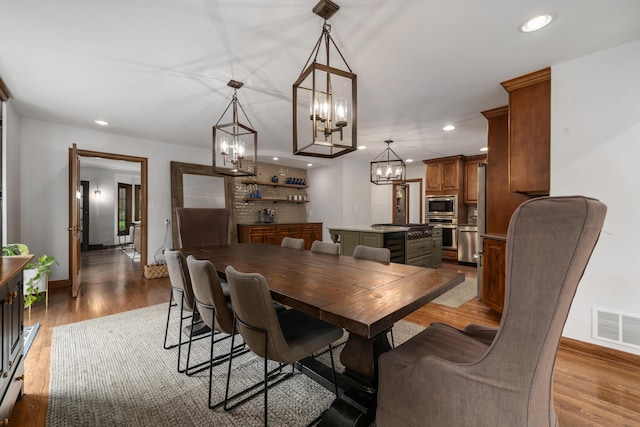 2656 Fair Ave, Columbus, OH 43209 - dining space with a chandelier, recessed lighting, baseboards, and light wood-style flooring