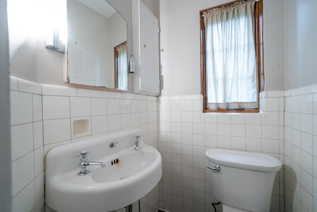 2656 Fair Ave, Columbus, OH 43209 - bathroom with tile walls, toilet, a sink, and a wainscoted wall