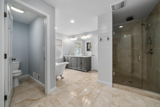 2656 Fair Ave, Columbus, OH 43209 - bathroom with a stall shower, double vanity, toilet, marble finish floors, and a freestanding tub