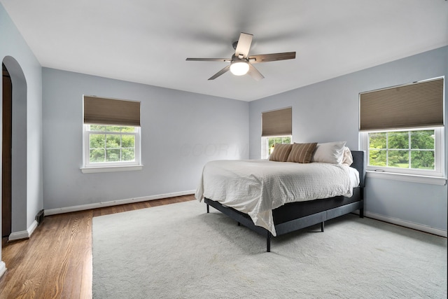 2656 Fair Ave, Columbus, OH 43209 - bedroom featuring arched walkways, wood finished floors, baseboards, and ceiling fan
