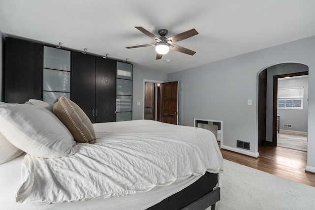 2656 Fair Ave, Columbus, OH 43209 - bedroom with arched walkways, wood finished floors, baseboards, and ceiling fan