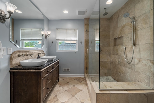 2656 Fair Ave, Columbus, OH 43209 - bathroom with double vanity, a stall shower, tile patterned floors, baseboards, and tasteful backsplash