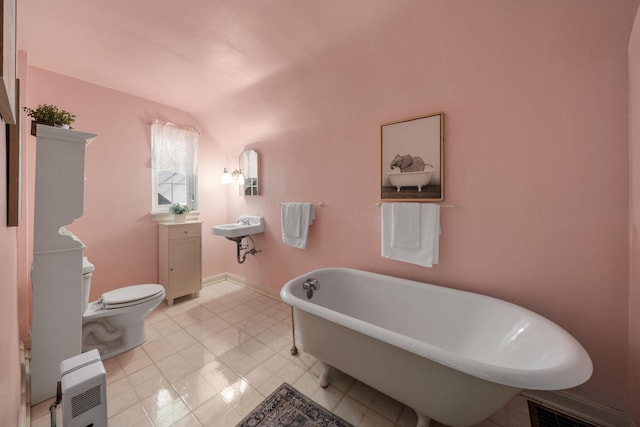 2656 Fair Ave, Columbus, OH 43209 - bathroom with a freestanding tub, toilet, vanity, and baseboards