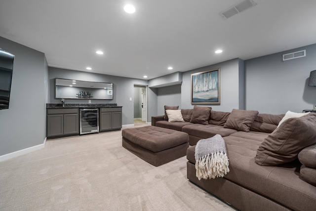 2656 Fair Ave, Columbus, OH 43209 - living area featuring beverage cooler, bar area, recessed lighting, baseboards, and light carpet