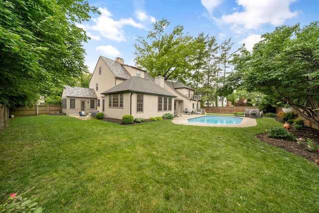 2656 Fair Ave, Columbus, OH 43209 - rear view of property featuring a patio, stucco siding, a shingled roof, and a chimney
