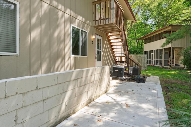 301 Fenway Rd Unit C, Columbus, OH 43214 - view of property exterior featuring central AC, a sunroom, a patio, and stairway