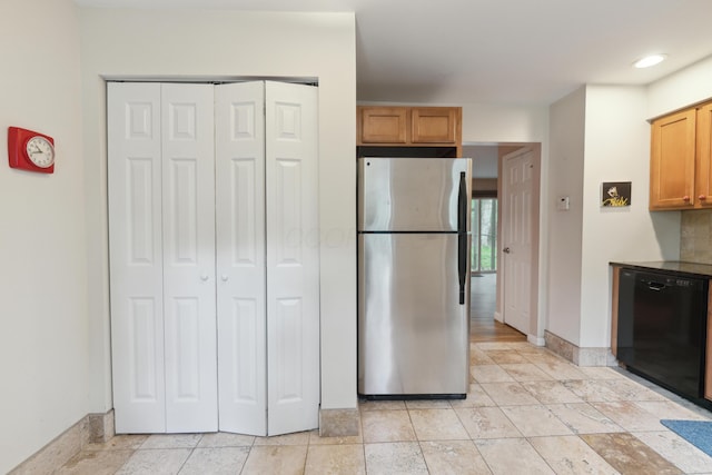 301 Fenway Rd Unit C, Columbus, OH 43214 - kitchen with black dishwasher, freestanding refrigerator, baseboards, and recessed lighting