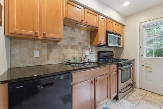 301 Fenway Rd Unit C, Columbus, OH 43214 - kitchen featuring stainless steel appliances, a sink, dark stone counters, decorative backsplash, and recessed lighting