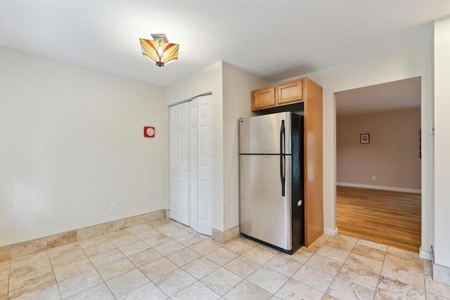 301 Fenway Rd Unit C, Columbus, OH 43214 - kitchen featuring freestanding refrigerator, baseboards, and light brown cabinets