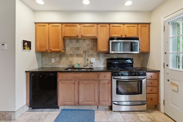301 Fenway Rd Unit C, Columbus, OH 43214 - kitchen featuring stainless steel appliances, a sink, decorative backsplash, dark stone counters, and recessed lighting