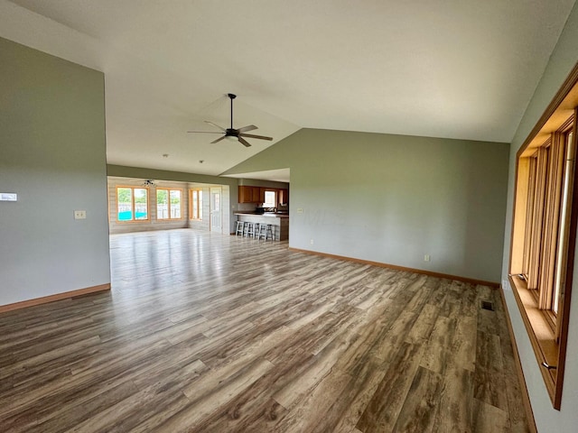 2580 Lafayette Plain City Rd, London, OH 43140 - unfurnished living room featuring dark wood-type flooring, lofted ceiling, ceiling fan, and baseboards