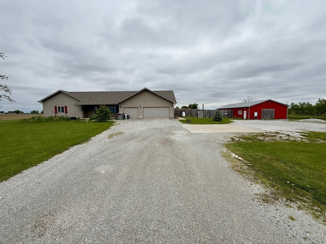 2580 Lafayette Plain City Rd, London, OH 43140 - view of front of property with gravel driveway, a garage, and a front yard