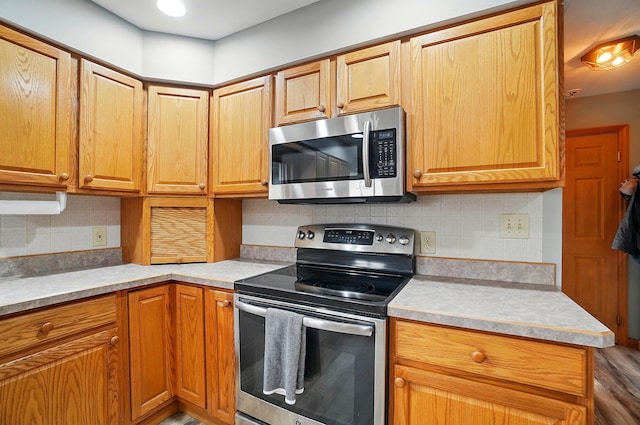 2580 Lafayette Plain City Rd, London, OH 43140 - kitchen featuring appliances with stainless steel finishes, light countertops, and decorative backsplash