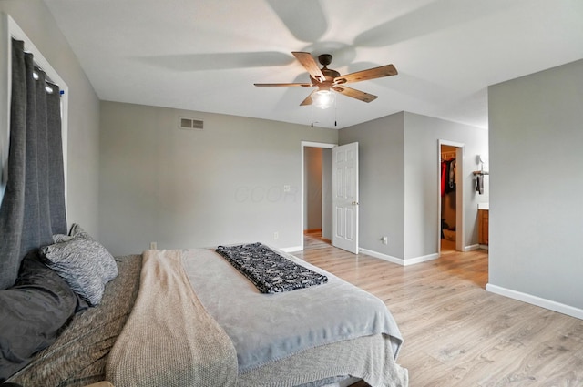2580 Lafayette Plain City Rd, London, OH 43140 - bedroom with light wood-type flooring, baseboards, a spacious closet, and a ceiling fan