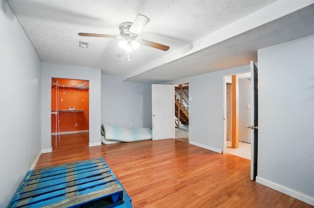 2580 Lafayette Plain City Rd, London, OH 43140 - unfurnished bedroom with wood finished floors, baseboards, a textured ceiling, and a ceiling fan